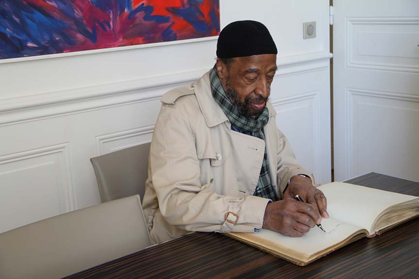 Yusef Lateef signing the visitor